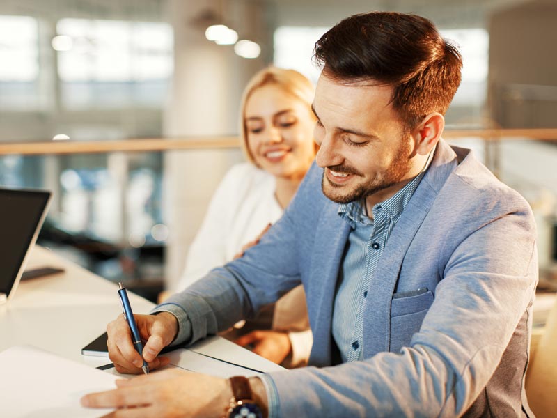 man signing loan