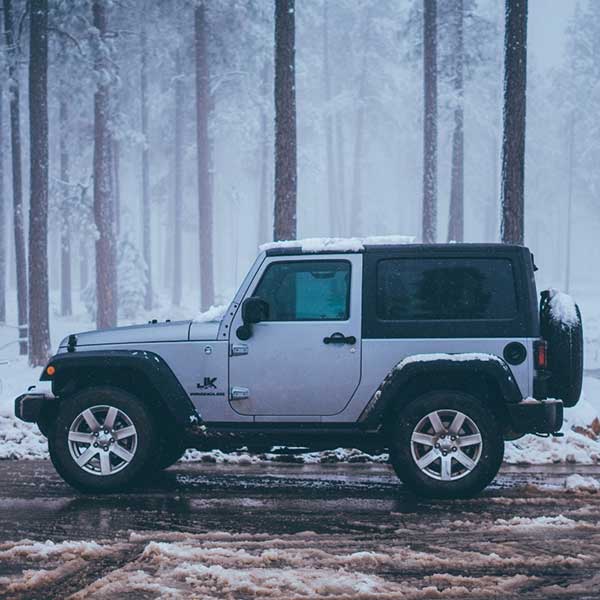 A jeep in a snow-covered forest area in DFW Metroplex
