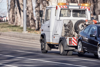 Tow truck carrying a repossessed vehicle.