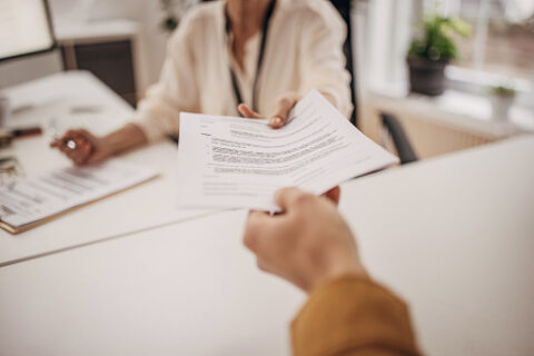 Women handing over title loan agreement
