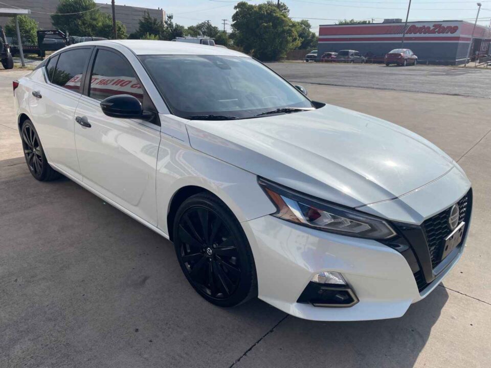 A White 2020 Nissan Altima with Black Alloy Wheels is Parked at an Angle in the DFW Metroplex